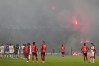 Players of Colombia's Independiente Medellin and Brazil's Flamengo stand on the field after the match was temporarily suspended because of crowd trouble during a Copa Libertadores Group A soccer match in Medellin, Colombia, Thursday, May 7, 2026. (AP Photo/Fernando Vergara)