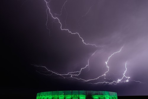 Lightning flashes beyond an office building as a thunderstorm passes in the distance, Monday, April 13, 2026, in Lenexa, Kan. THE CANADIAN PRESS/AP-Charlie Riedel