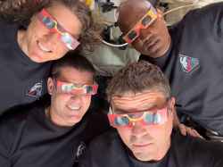 The Artemis II crew pose with eclipse viewers. Counterclockwise from top left: Mission Specialist Christina Koch, Mission Specialist Jeremy Hansen, Commander Reid Wiseman, and Pilot Victor Glover. (NASA / The Associated Press)