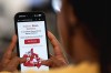 A person looks at a phone showing the website of a new Canadian-based social media platform, Northsocial.ca, in a photo illustration made in Toronto, Thursday, April 9, 2026. THE CANADIAN PRESS/Giordano Ciampini