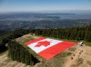 A giant Canadian flag is seen spread out on The Cut, ski run at Metro Vancouver's Grouse Mountain ski resort, in this undated handout photo. THE CANADIAN PRESS/Handout — Grouse Mountain Resort (Mandatory Credit)