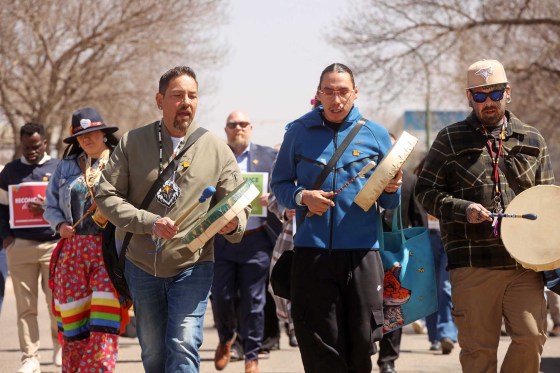 Jason Gobeil (left) with the Good Hearted Warriors men's group and other drummers lead the Moose Hide Campaign Community Walk in Brandon on Thursday. (Tim Smith / The Brandon Sun)