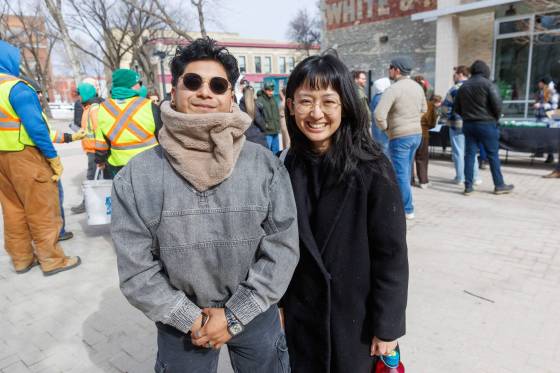 Jasmin Knight (right), from the Heartland International English School, along with student Omar Sanchez (left), take part the Exchange District’s Spruce Spring cleanup on Thursday. (Mike Deal / Free Press)