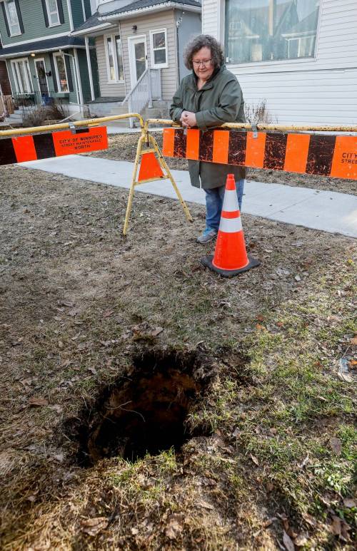 JOHN WOODS / FREE PRESs fileS
                                Christine Keilback by the hole that swallowed her whole.