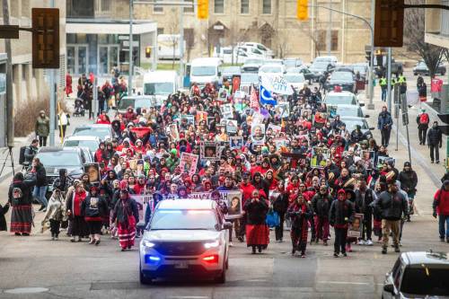 MIKAELA MACKENZIE / FREE PRESS
                                Hundreds of people marched east from the Winnipeg Law Courts to Oodena Celebration Circle at The Forks to mark Red Dress Day.