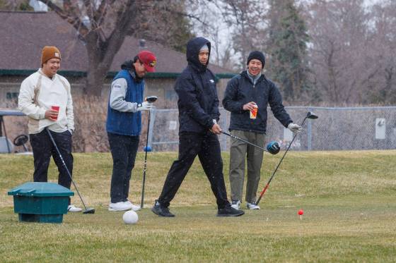 Falling snow and cool temperatures Tuesday morning didn’t deter Joyous Vasquez (approaching ball) from hitting the links at Kildonan Park Golf Course with friends, from left, Errol Manimtim, Steve Santiago, and Mike Martin. (Mike Deal / Free Press)