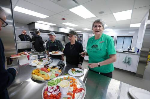 RUTH BONNEVILLE / FREE PRESS
                                Agape Table volunteer Donna Hewey (right) serves up refreshments from a large kitchen at the new Agape Table building oon Furby Street.