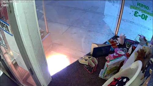 SUPPLIED
                                A still image from security footage showing a fire on May 3 at the entrance of Just Like New to You.