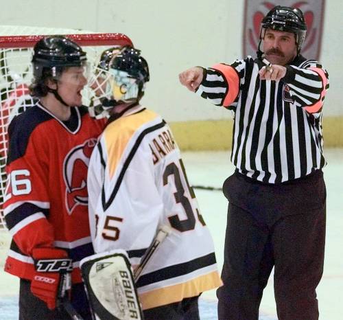 Chris Gardner / Canadian Press files
                                In this 1999 photo, Bill McCreary (right) signals towards Pittsburgh Penguins goalie Tom Barrasso (centre) and Patrik Elias of the New Jersey Devils. McCreary officiated 1,737 regular season games and 297 playoff games in the NHL, including 44 Stanley Cup finals games.