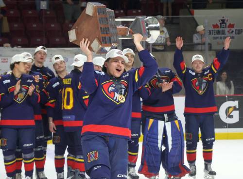 Marlen Edwards lifts the Centennial Cup into the air after helping the Niverville Nighthawks to a national championship. (Cassidy Dankochik / The Carillon)