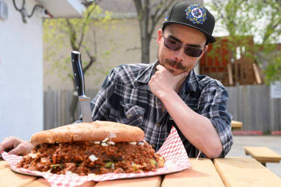 Curtis Kalmakoff sizes up the challenge before he tries to eat the World's Largest Fatboy (equivalent to 12 regular-sized fatboys) in less than 30 minutes at St. James Burger and Chip Co. on Tuesday. Did he succeed? Reporter AV Kitching was there. (Mike Sudoma / Free Press)