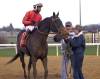 JASON HALSTEAD / @assiniboia photo
                                Trainer Jerry Gourneau (centre) helps HPBA groom school graduate Charlotte Stevens with Brooklyn Alley Cat after winning the second race on Wednesday with jockey Dario Dalrymple.