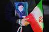 A demonstrator holds a poster of the slain Iranian Supreme Leader Ayatollah Ali Khamenei, who was killed in the U.S. and Israel strike on Feb. 28, and an Iranian flag during a pro-government gathering in downtown Tehran. Khamenei published a fatwa in 2004 forbidding Muslims to use nuclear weapons. (Vahid Salemi / The Associated Press files)