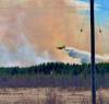 LESLIE ARROW PHOTO A water bomber fights a wildfire southwest of Chemawawin Cree Nation on Tuesday.