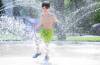 RUTH BONNEVILLE / FREE PRESS
                                Six-year-old Moses Hunter cools himself off in the splash pad at Provencher Park on Wednesday afternoon.
