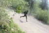 A person is seen in surveillance video running down a road after a shooting in Pelican Narrows, Sask., on Monday, June 1, 2026. Police are looking for help in identifying this person. THE CANADIAN PRESS/Handout - RCMP (Mandatory Credit)