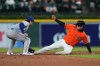 Detroit Tigers' Kerry Carpenter, right, steals second base under the tag of Texas Rangers second baseman Josh Smith, left, during the fifth inning of a baseball game Friday, May 1, 2026, in Detroit. (AP Photo/Paul Sancya)