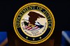 The U.S. Department of Justice logo is seen on a podium before a news conference, Monday, May 4, 2026, in Washington. (AP Photo/Julia Demaree Nikhinson)