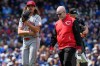 Cincinnati Reds starting pitcher Rhett Lowder, left, leaves as he talks with a team trainer after an injury during the fourth inning of a baseball game against the Chicago Cubs in Chicago, Thursday, May 7, 2026. (AP Photo/Nam Y. Huh)