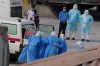 FILE - Health workers in protective gear evacuate patients from the MV Hondius cruise ship into an ambulance at a port in Praia, Cape Verde, May 6, 2026. (AP Photo/Misper Apawu, File)