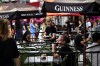 A server works on the patio of a pub in the ByWard Market in Ottawa, on Friday, June 23, 2023. THE CANADIAN PRESS/Justin Tang