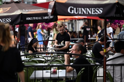 A server works on the patio of a pub in the ByWard Market in Ottawa, on Friday, June 23, 2023. THE CANADIAN PRESS/Justin Tang