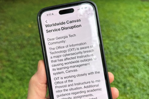 An image of a notice sent by Georgia Tech's information technology department warning students, professors and staff about the cybersecurity breach of the Canvas system it uses for assignments and grading is displayed on a phone, Friday, May 8, 2026, in Decatur, Georgia. (AP Photo/Michael Warren)