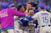 Kansas City Royals players celebrate after Kyle Isbel hit a single to drive in the game-winning run during the ninth inning of a baseball game against the Detroit Tigers, Friday, May 8, 2026, in Kansas City, Mo. (AP Photo/Charlie Riedel)