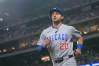 Texas Rangers second baseman Ezequiel Duran scores on a single by teammate Ian Happ during the first inning of a baseball game against the Texas Rangers Friday, May 8, 2026, in Arlington, Texas. (AP Photo/Julio Cortez)
