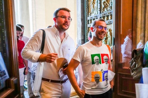 FILE - Members of the LGBTQ+ Catholics and their families who joined a Holy Year pilgrimage to Rome walk through the Holy Door of St. Peter's Basilica at the Vatican, Saturday, Sept. 6, 2025. (AP Photo/Andrew Medichini, File)