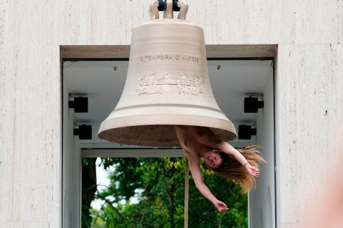 EDS NOTE: NUDITY - A performer rings a bell with her body at the Austrian pavilion called 'Seaworld Venice' by artist Ei Arakawa-Nash, at the Venice 2026 Biennale Art, in Venice, Italy, Thursday, Nov. 14, 2024. (AP Photo/Luca Bruno)