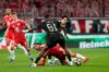 PSG's Willian Pacho, foreground, stops Bayern's Jamal Musiala during the Champions League semifinal second leg soccer match between Bayern Munich and Paris Saint Germain in Munich, Germany, Wednesday, May 6, 2026. (AP Photo/Martin Meissner)