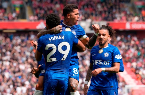 Chelsea's Enzo Fernandez (top) celebrates with team-mate Wesley Fofana after scoring their side's first goal of the game during the Premier League soccer match between Liverpool and Chelsea in Liverpool, England, Saturday, May 9, 2026. (Peter Byrne/PA via AP)