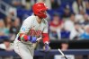 Philadelphia Phillies' Bryce Harper watches his hit after breaking his bat on a single during the eighth inning of a baseball game against the Miami Marlins, Monday, May 4, 2026, in Miami. (AP Photo/Rebecca Blackwell)