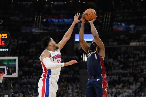 Cleveland Cavaliers guard James Harden (1) shoots as Detroit Pistons forward Tobias Harris (12) defends in the first half of Game 3 of a second-round NBA playoffs basketball series Saturday, May 9, 2026 in Cleveland. (AP Photo/Sue Ogrocki)