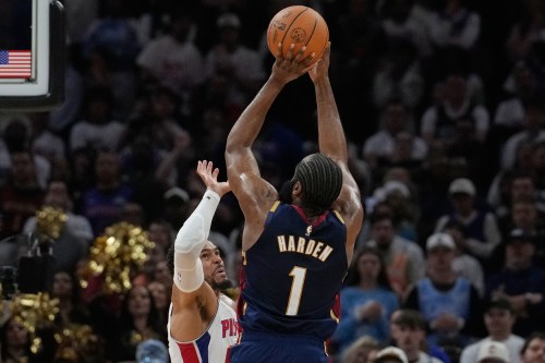 Cleveland Cavaliers guard James Harden (1) shoots over Detroit Pistons forward Tobias Harris, left, in the second half of Game 3 of a second-round NBA playoffs basketball series Saturday, May 9, 2026 in Cleveland. (AP Photo/Sue Ogrocki)