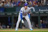 Chicago Cubs' Ian Happ leads off first base after collecting a hit off Texas Rangers starting pitcher Kumar Rocker during the first inning of a baseball game Friday, May 8, 2026, in Arlington, Texas. (AP Photo/Julio Cortez)