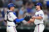 Texas Rangers catcher Kyle Higashioka, left, and pitcher Gavin Collyer react after defeating the Chicago Cubs 6-0 during a baseball game Saturday, May 9, 2026, in Arlington, Texas. (AP Photo/Julio Cortez)