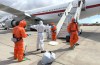 A Spanish passenger is sprayed with disinfectant by Spanish government officials before boarding a plane after disembarking from the hantavirus-stricken cruise ship MV Hondius at Tenerife airport in the Canary Islands, Spain, Sunday, May 10, 2026. (AP Photo)
