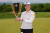 Jeeno Thitikul, of Thailand, poses for a picture with the trophy after winning the Mizuho Americas Open golf tournament, Sunday, May 10, 2026, in West Caldwell, N.J. (AP Photo/Seth Wenig)