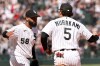 Chicago White Sox pitcher Seranthony Domínguez (58) celebrates after the team's win against the Seattle Mariners with first baseman Munetaka Murakami (5), Sunday, May 10, 2026, in Chicago. (AP Photo/Geoff Stellfox)