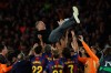 Barcelona head coach Hansi Flick is lifted by his players after winning the Spanish La Liga soccer match against Real Madrid to clinch the Spanish league title in Barcelona, Spain, Sunday, May 10, 2026. (AP Photo/Joan Monfort)