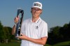 Kristoffer Reitan, of Norway, poses with the trophy after winning the Truist Championship golf tournament at the Quail Hollow Club, Sunday, May 10, 2026, in Charlotte, N.C. (AP Photo/Chris Carlson)