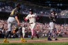 San Francisco Giants' Christian Koss, center, scores against the Pittsburgh Pirates on Willy Adames' single during the 10th inning of a baseball game Sunday, May 10, 2026, in San Francisco. (AP Photo/Godofredo A. Vásquez)