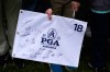 A fan holds a flag while waiting for autographs during practice before the PGA Championship golf tournament at the Aronimink Golf Club Monday, May 11, 2026, in Newtown Square, Pa. (AP Photo/Matt Slocum)