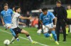 Bologna's Joao Pedro, second left, challenges for the ball with Napoli's Alisson Santos during the Italian Serie A soccer match between Napoli and Bologna in Naples, Italy, Monday, May 11, 2026. (Alessandro Garofalo/LaPresse via AP)