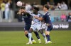 San Jose Earthquakes forward Ousseni Bouda, middle, looks toward the ball between Vancouver Whitecaps defender Tristan Blackmon, left, and midfielder Sebastian Berhalter (16) during the first half of an MLS soccer match Saturday, May 9, 2026, in San Jose, Calif. (AP Photo/Jeff Chiu)