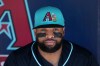 FILE - Arizona Diamondbacks' Carlos Santana sits in the team dugout prior to a spring training baseball game against the Kansas City Royals Thursday, Feb. 26, 2026, in Scottsdale, Ariz. (AP Photo/Ross D. Franklin,File)