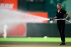 FILE - Baltimore Orioles head groundskeeper Nicole Sherry sprays the field before a baseball game between the Orioles and the Atlanta Braves, Wednesday, June 12, 2024, in Baltimore. (AP Photo/Nick Wass,File)