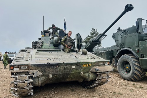 Swedish servicemen looks out of an armoured vehicle during a military exercises in Gotland, Sweden, Monday, May 11, 2026. (AP Photo/Emma Burrows)